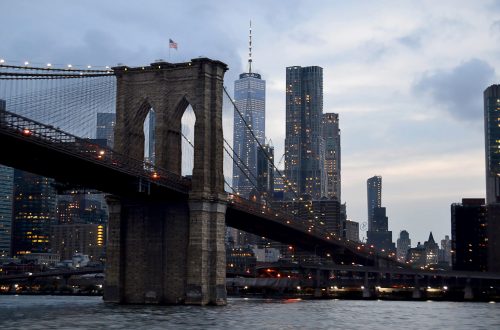 A landscape shot of brooklyn bridge in the new USA with a gray gloomy sky